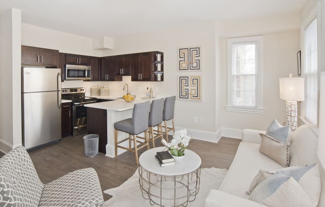 a living room and kitchen with a white couch and a table