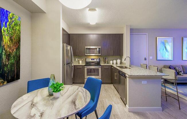 a kitchen and dining room with a table and chairs at Icon One, Florida, 32114
