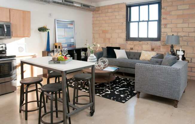 Exposed Brick Wall in Living Room at 700 Central Apartment Unit