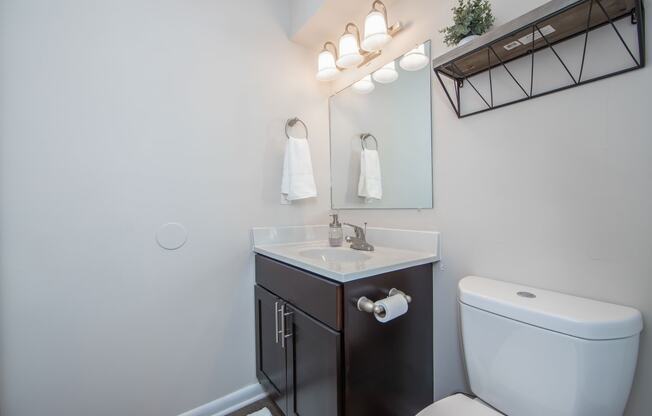 Bathroom with single sink cabinet and toilet in Brittany Place Apartments in Norfolk VA