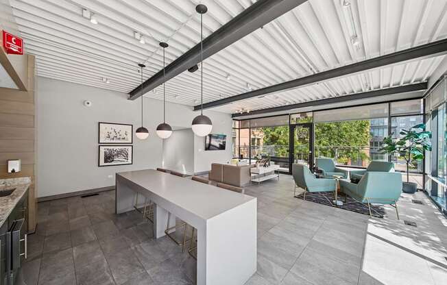 A modern kitchen with a dining area and a view of the outdoors.