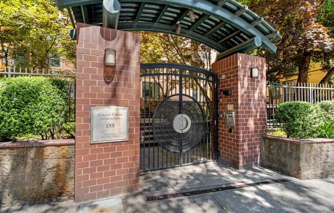 a gate to a park with a brick gate