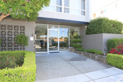 Front of 36th ave Apartments a building with large windows facing the street side