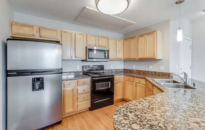 a kitchen with granite counter tops and stainless steel appliances