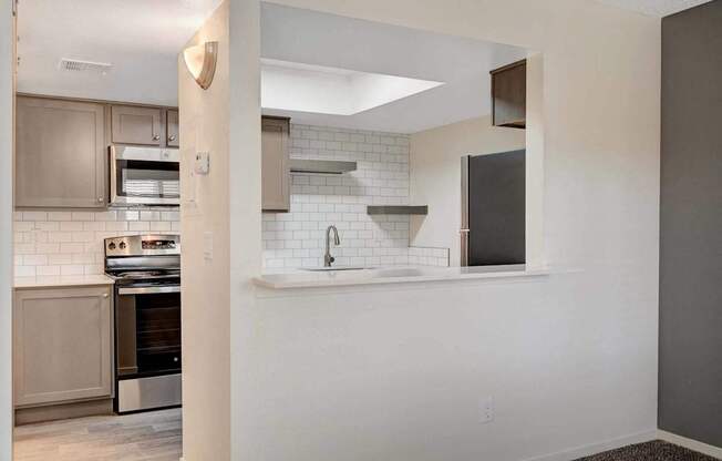 A kitchen with a stove top oven and a microwave.