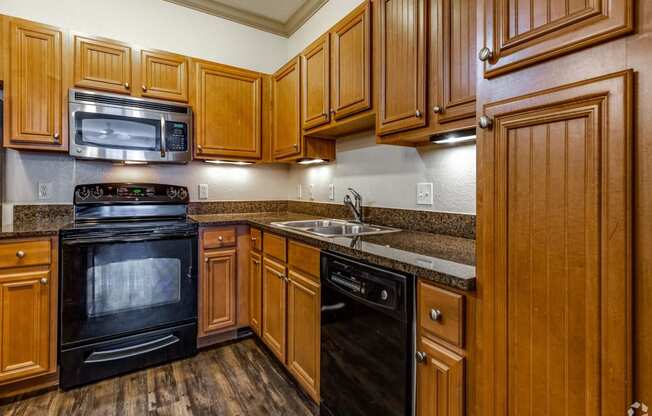 a kitchen with wood cabinets and black appliances