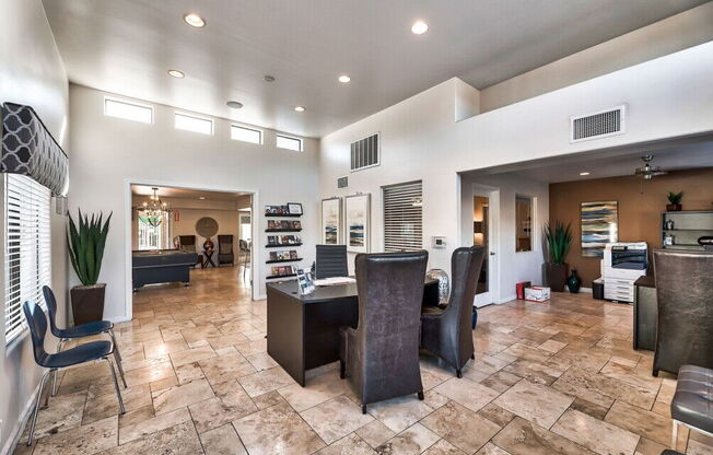 a living room and dining room with a table and chairs