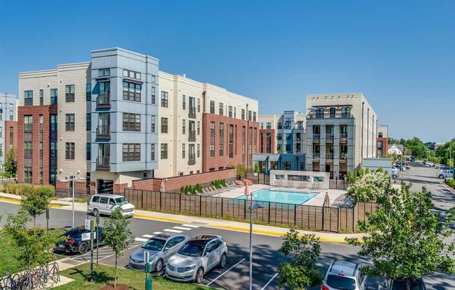 an aerial view of an apartment complex with a swimming pool