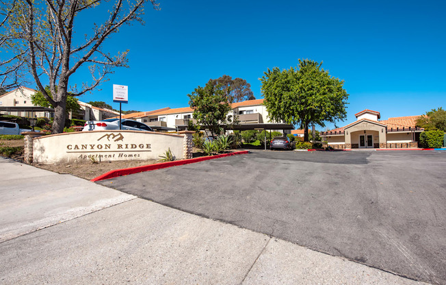 A sign that says Canyon Ridge in front of a building.