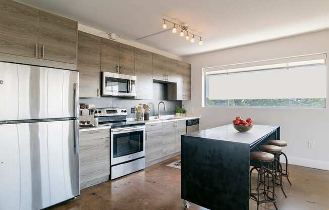 a modern kitchen with stainless steel appliances and wooden cabinets