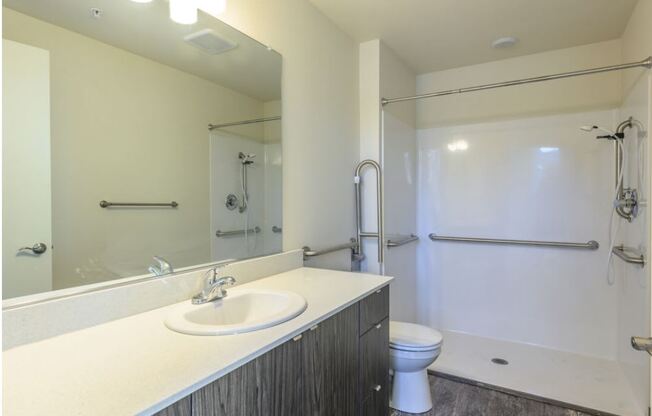 a bathroom with a sink toilet and shower