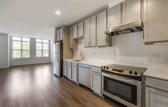 a kitchen with white cabinets and a stove