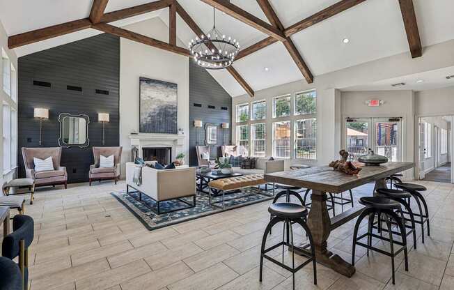 A large open living room with a fireplace and a dining table.