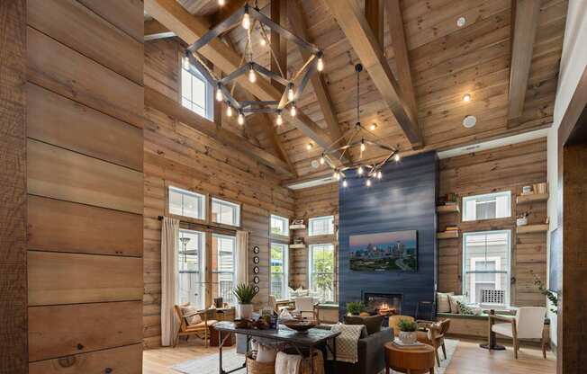 A wooden house with a large living room and a fireplace.