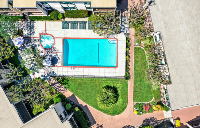 an aerial view of a pool and a yard with a tennis court at Casa Del Amo Apartments, California, 90505