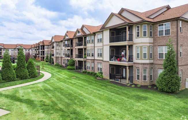 A row of houses with a green lawn in front.