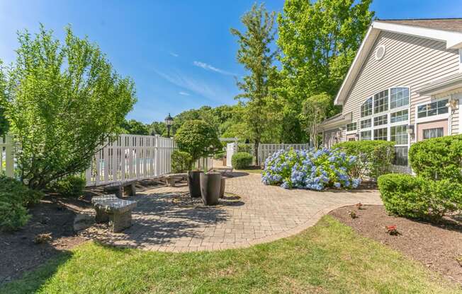 a backyard with a patio and trees and a house