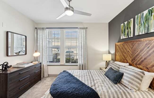 a bedroom with a large bed and a ceiling fan