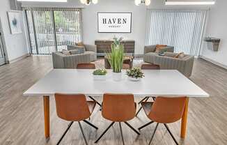 a dining room with a white table and chairs