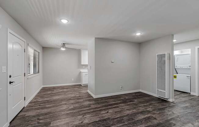 A spacious room with a washer and dryer in it.