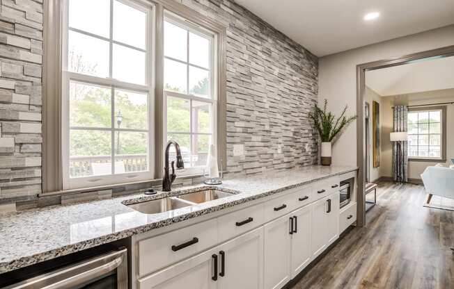 clubhouse kitchen with granite-style countertops and white cabinetry