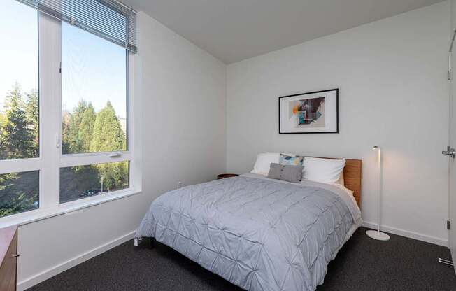 a bedroom with a bed and a wallpaper on the wall