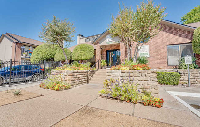 A blue car is parked in front of a house.