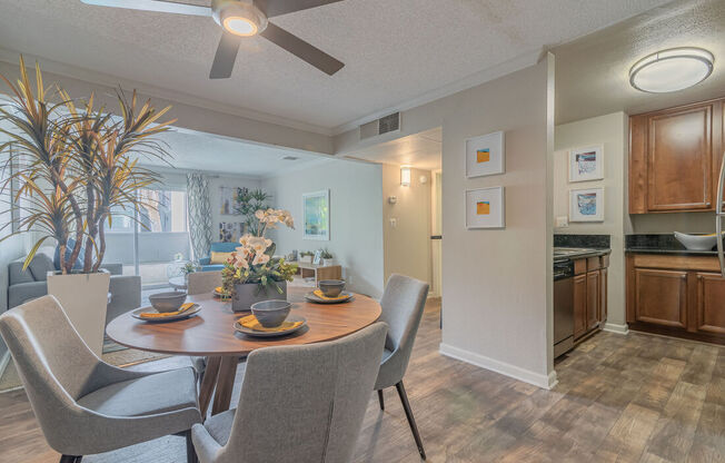 a dining room and kitchen with a table and chairs at City View Apartments at Warner Center, Woodland Hills, CA 91367