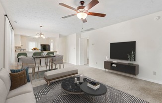 a living room with a couch and a ceiling fan