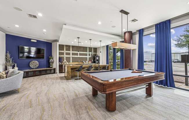 Stylish clubroom with a pool table and seating areas at Allusion at West University apartments in Houston, TX