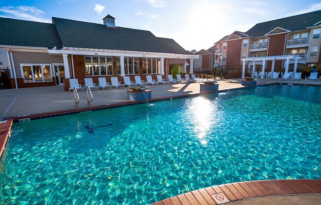 sun setting over the pool behide the clubhouse at 1200 Acqua Apartment homes near Fort Lee Virginia