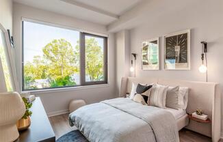 RiverPoint apartments in Washington, DC spacious bedroom with expansive windows allowing natural light