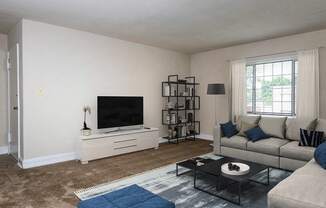 a living room with a couch and a tv at Hamilton Manor Apartments, Maryland