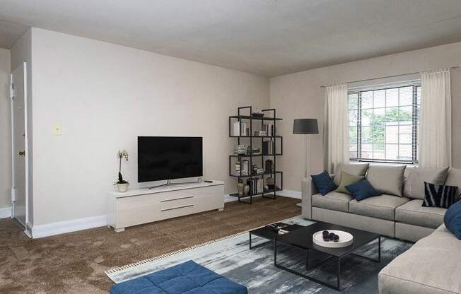 a living room with a couch and a tv at Hamilton Manor Apartments, Maryland