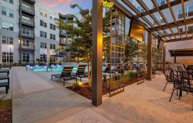 apartments with a pool and patio at dusk