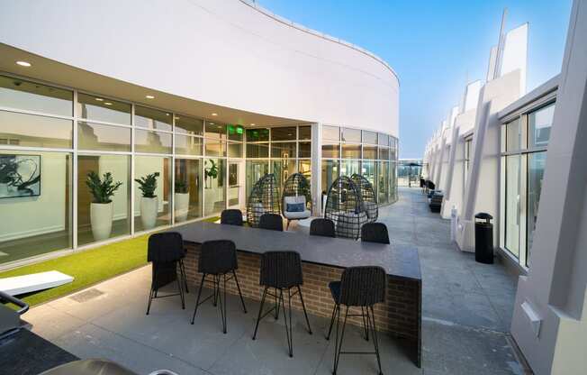 a large table with chairs outside of a building