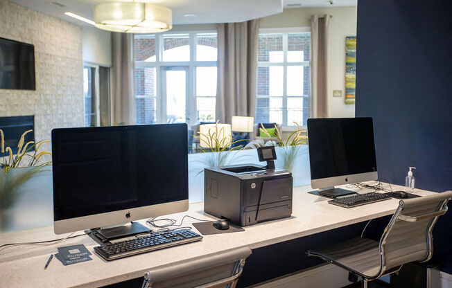 a desk with two monitors and a computer on it