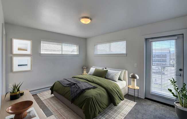 A bedroom with a bed, nightstand, and window.