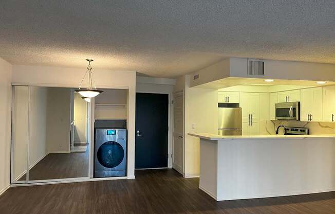 A laundry room with a washer and dryer is shown.