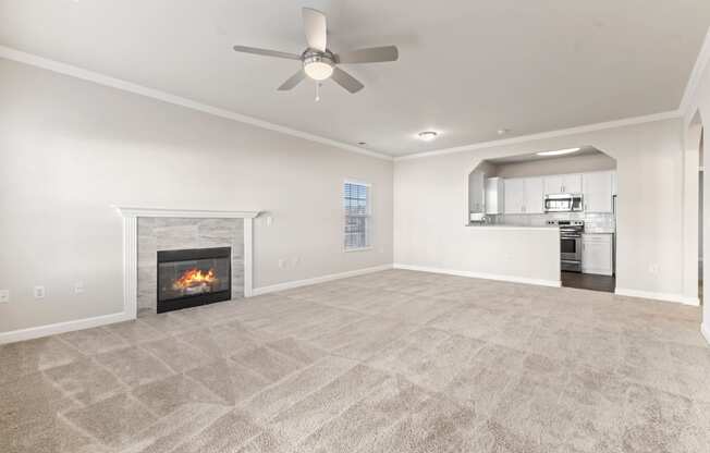 a living room with a fireplace and a ceiling fan