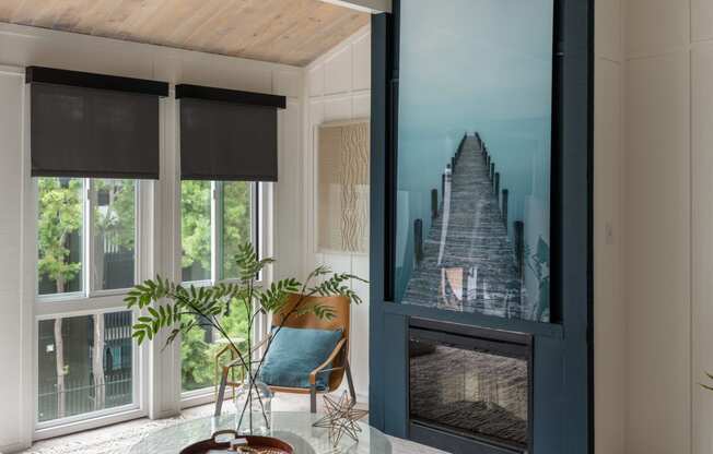 a living room with a fireplace and a large picture of a staircase