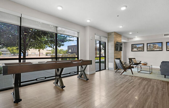 a living room with a piano and a large window