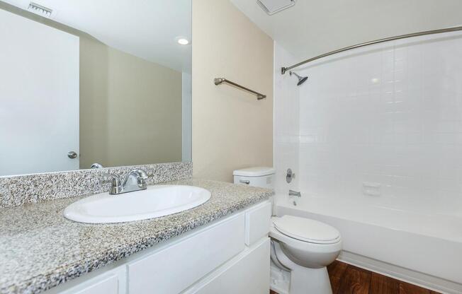 a large white tub next to a sink