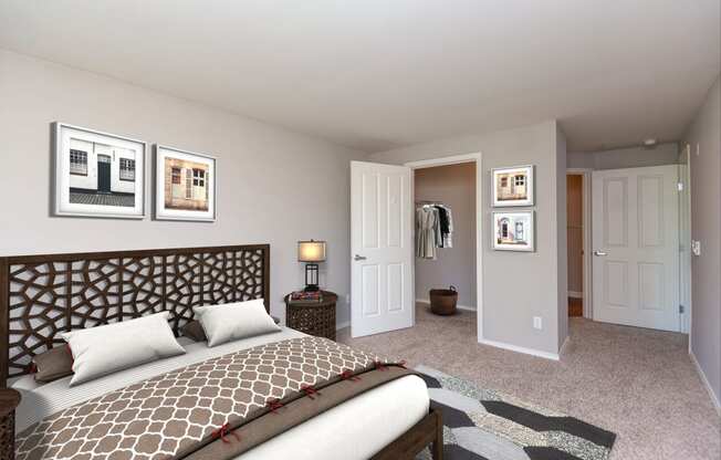 3-Bedroom Apartments in Issaquah, WA - Langara - Bedroom with Carpet Flooring, Full Size Bed, Nightstand with Lamp, Framed Wall Art, and Large Closet.