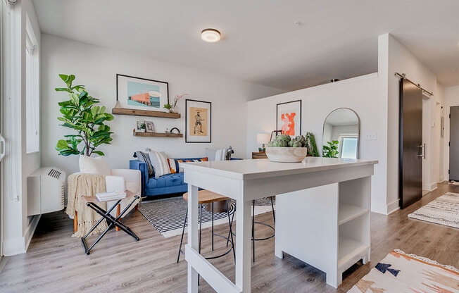 an open kitchen and living room with a white counter top