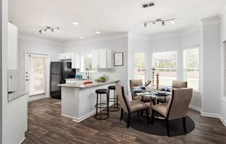 a kitchen and dining room with a table and chairs