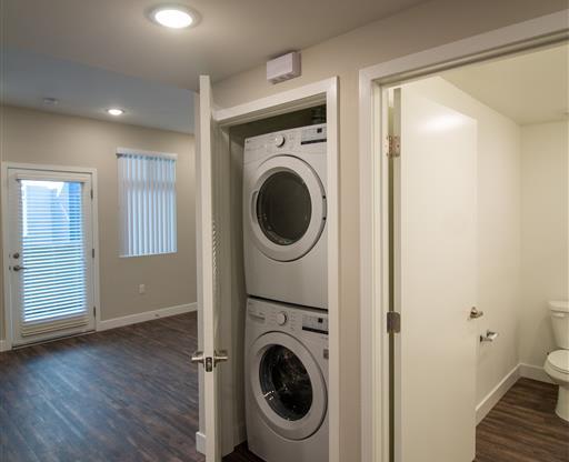 a washer and dryer in a room with a toilet at Loma Villas Apartments, San Bernardino, 92408