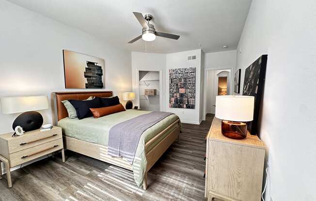 a bedroom with a bed and a ceiling fan