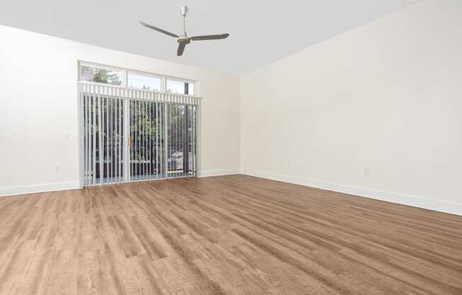 a bedroom with hardwood floors and white walls