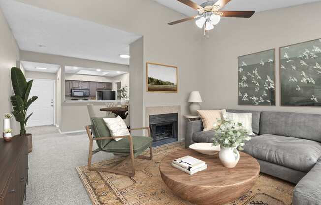 an open living room with a fireplace and a ceiling fan